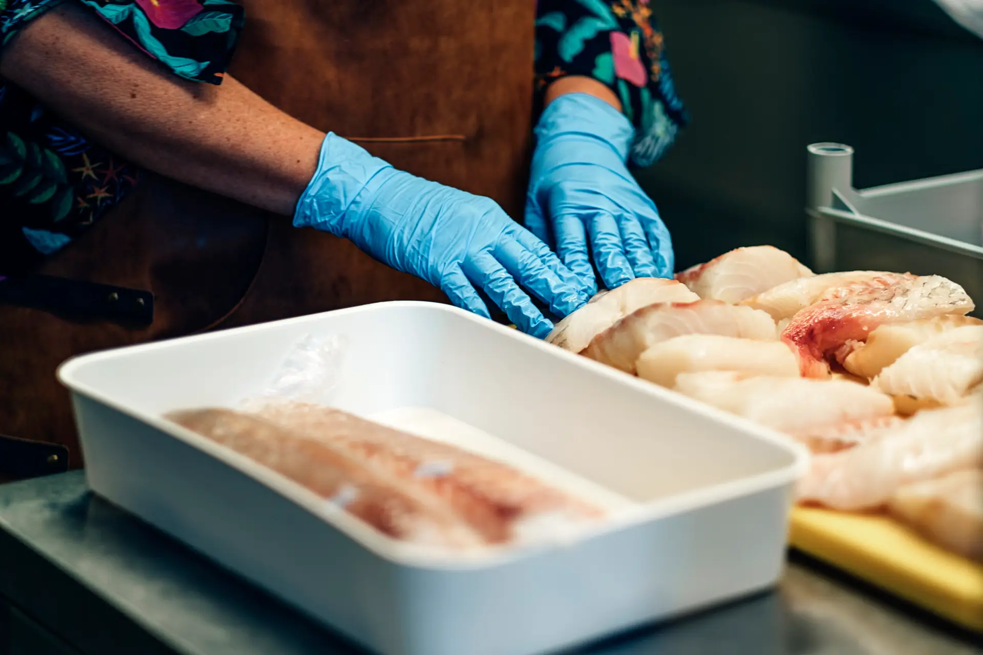 chopped raw fish pieces ready in a restaurant kitchen